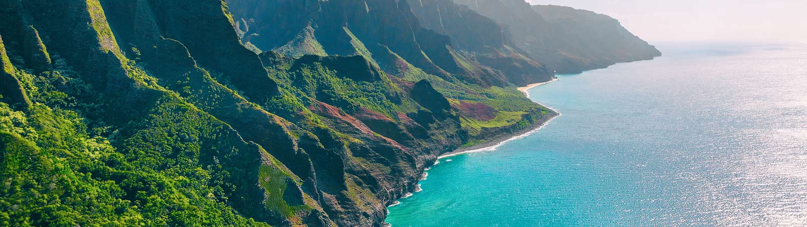 An aerial landscape view of beautiful Kauai showing the dramatic Na Pali coast on a Hawaii vacation